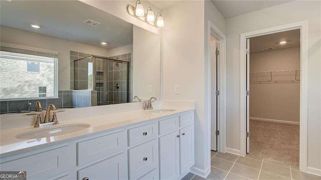 308 Delta Dr, Mcdonough, GA 30253 - bathroom with a shower stall, a spacious closet, double vanity, tile patterned flooring, and baseboards