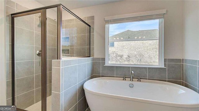 308 Delta Dr, Mcdonough, GA 30253 - bathroom with a soaking tub and a shower stall