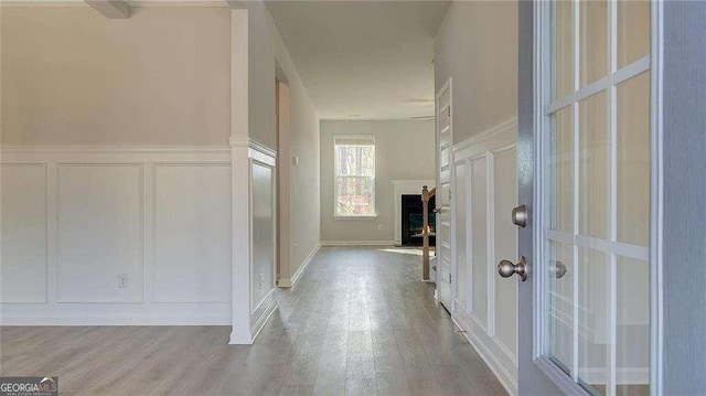 308 Delta Dr, Mcdonough, GA 30253 - hallway with a decorative wall, wood finished floors, and a wainscoted wall