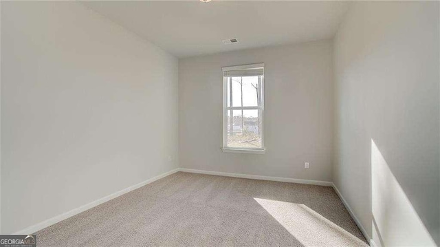 308 Delta Dr, Mcdonough, GA 30253 - empty room featuring light colored carpet and baseboards