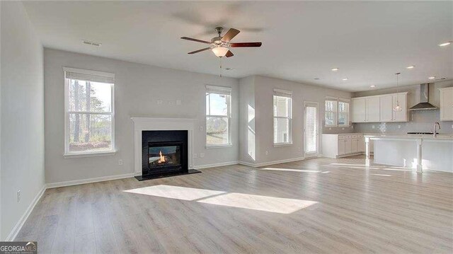 308 Delta Dr, Mcdonough, GA 30253 - unfurnished living room with healthy amount of natural light, a ceiling fan, light wood-style flooring, and recessed lighting