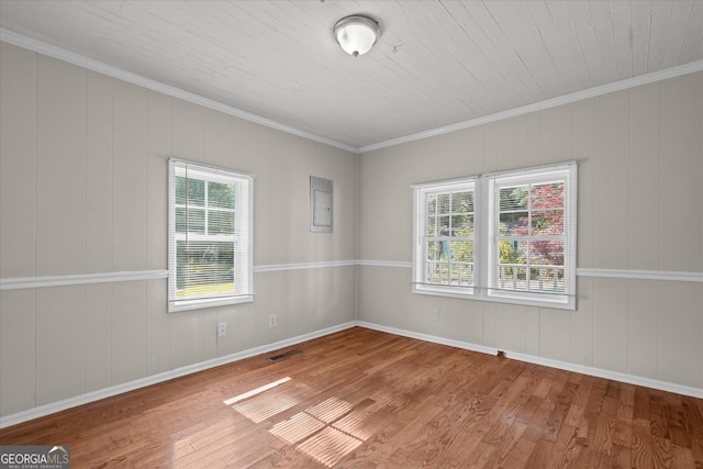 206 Brown St, Carrollton, GA 30117 - spare room featuring wood finished floors, ornamental molding, healthy amount of natural light, electric panel, and baseboards