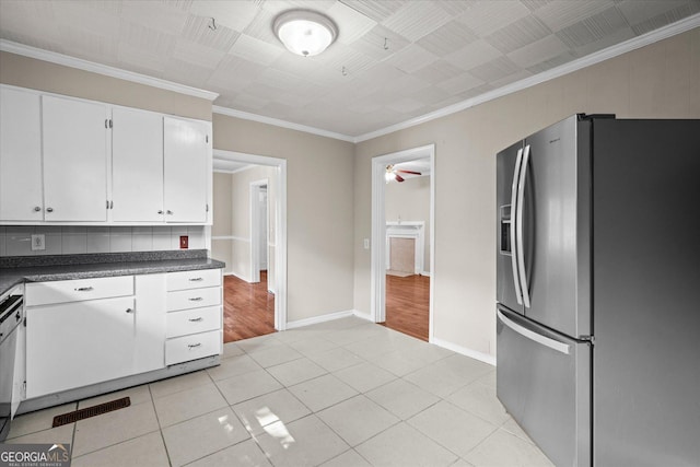 206 Brown St, Carrollton, GA 30117 - kitchen featuring stainless steel fridge, dark countertops, white cabinetry, baseboards, and ornamental molding