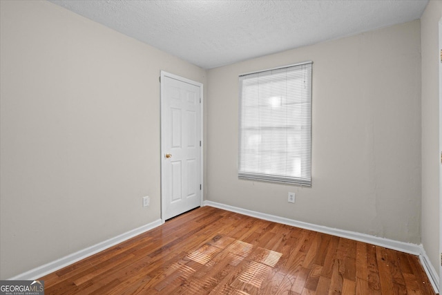 206 Brown St, Carrollton, GA 30117 - unfurnished room with baseboards, wood finished floors, and a textured ceiling
