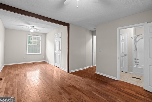 206 Brown St, Carrollton, GA 30117 - spare room featuring ceiling fan, wood finished floors, a textured ceiling, and baseboards