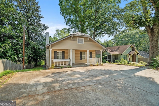 206 Brown St, Carrollton, GA 30117 - view of front of property with covered porch, a chimney, and driveway