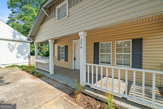 206 Brown St, Carrollton, GA 30117 - doorway to property with board and batten siding and a porch