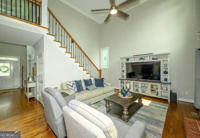 1409 Echo Mill Dr, Powder Springs, GA 30127 - living room with a ceiling fan, wood finished floors, a high ceiling, and stairs