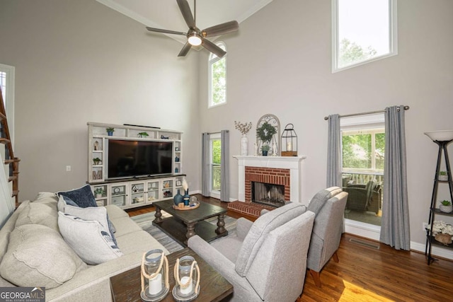 1409 Echo Mill Dr, Powder Springs, GA 30127 - living area with a high ceiling, plenty of natural light, ceiling fan, wood finished floors, and a brick fireplace