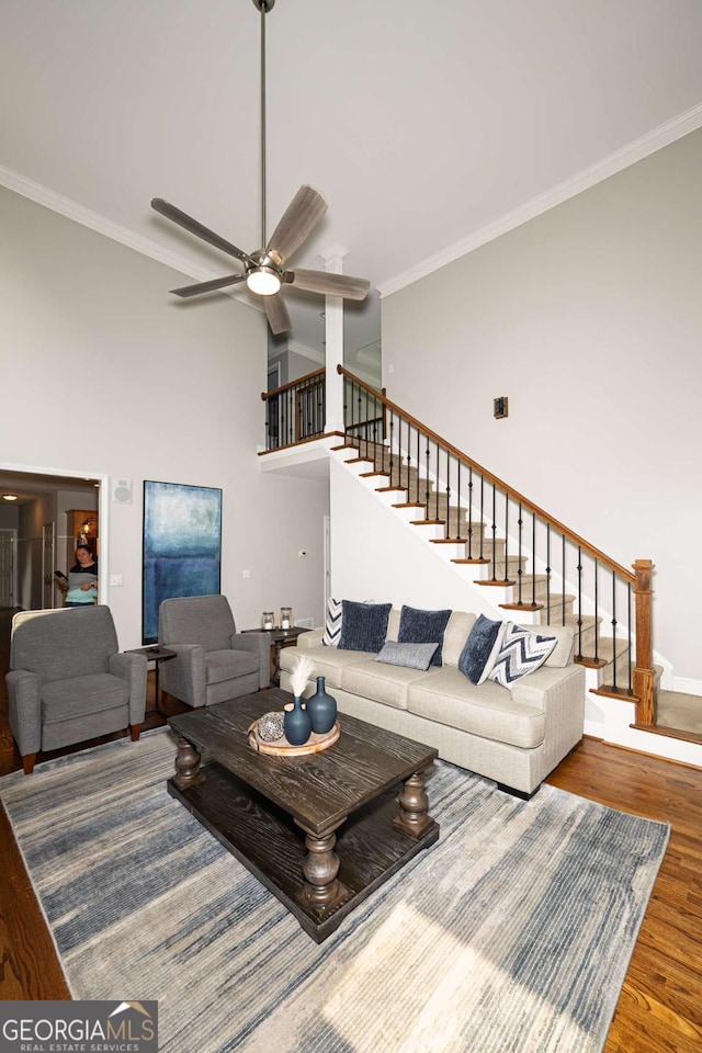 1409 Echo Mill Dr, Powder Springs, GA 30127 - living room with stairs, wood finished floors, crown molding, ceiling fan, and baseboards