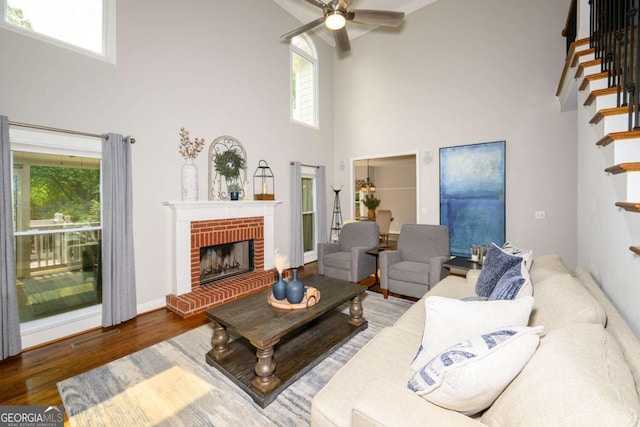 1409 Echo Mill Dr, Powder Springs, GA 30127 - living room featuring a towering ceiling, plenty of natural light, wood finished floors, a ceiling fan, and stairs