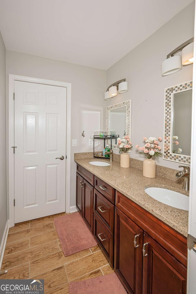 1409 Echo Mill Dr, Powder Springs, GA 30127 - bathroom featuring double vanity and baseboards