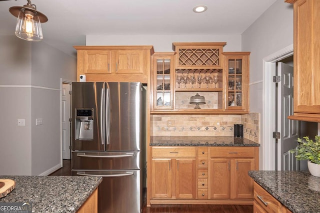 1409 Echo Mill Dr, Powder Springs, GA 30127 - kitchen featuring stainless steel fridge, dark stone countertops, glass insert cabinets, decorative backsplash, and recessed lighting