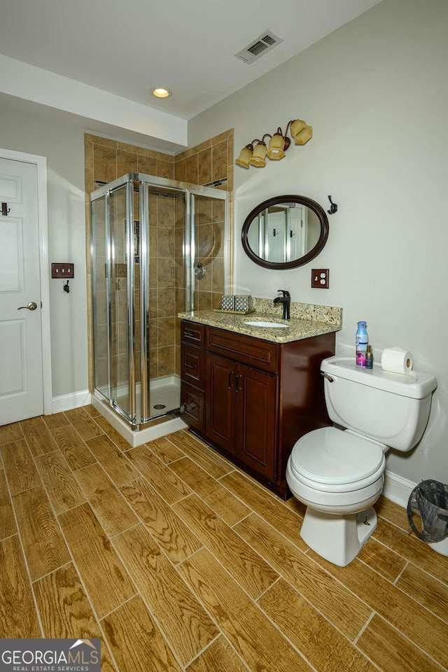 1409 Echo Mill Dr, Powder Springs, GA 30127 - full bathroom with wood finish floors, toilet, vanity, and a shower stall