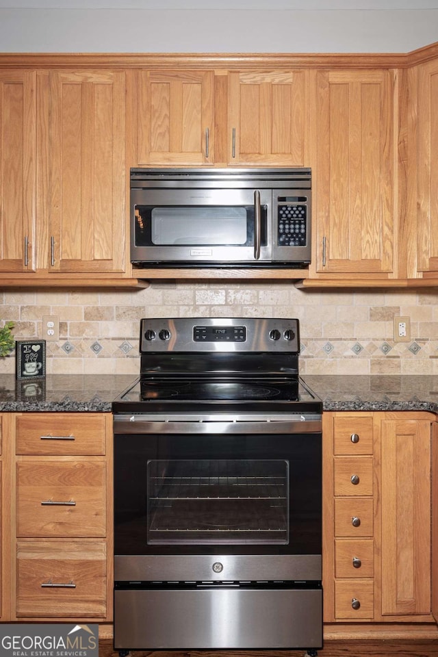 1409 Echo Mill Dr, Powder Springs, GA 30127 - kitchen featuring appliances with stainless steel finishes, tasteful backsplash, and dark stone counters