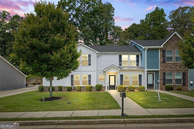 5880 Garden Cir, Douglasville, GA 30135 - view of front facade featuring board and batten siding, stone siding, and a front yard