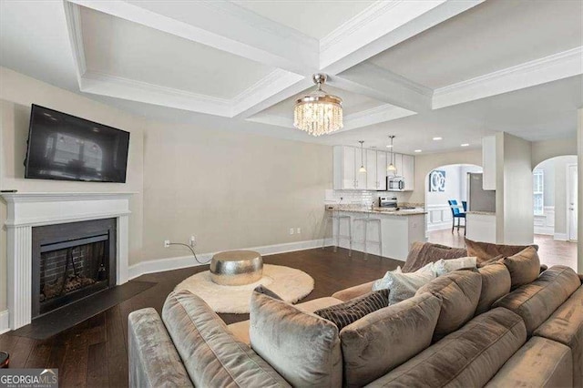 5880 Garden Cir, Douglasville, GA 30135 - living area featuring arched walkways, coffered ceiling, a chandelier, wood finished floors, and baseboards