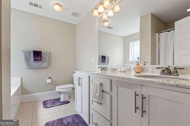 5880 Garden Cir, Douglasville, GA 30135 - bathroom with double vanity, toilet, tile patterned flooring, a garden tub, and baseboards