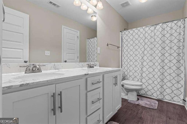 5880 Garden Cir, Douglasville, GA 30135 - full bathroom with toilet, double vanity, wood finished floors, and a shower with shower curtain
