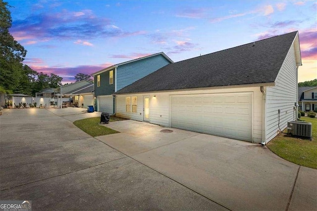 5880 Garden Cir, Douglasville, GA 30135 - traditional-style home featuring driveway, central air condition unit, a garage, and roof with shingles