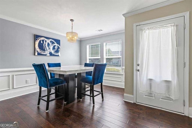 5880 Garden Cir, Douglasville, GA 30135 - dining area with crown molding, dark wood-style floors, and wainscoting
