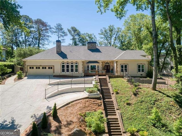 511 Pine Valley Rd SE, Marietta, GA 30067 - rear view of property with stairs, driveway, a garage, and a chimney