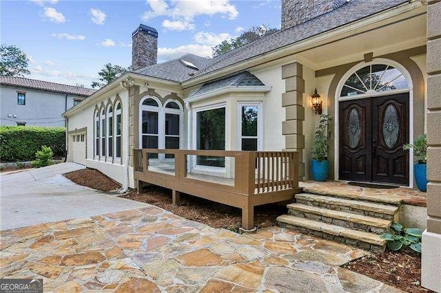 511 Pine Valley Rd SE, Marietta, GA 30067 - doorway to property with a chimney, driveway, a garage, and stucco siding