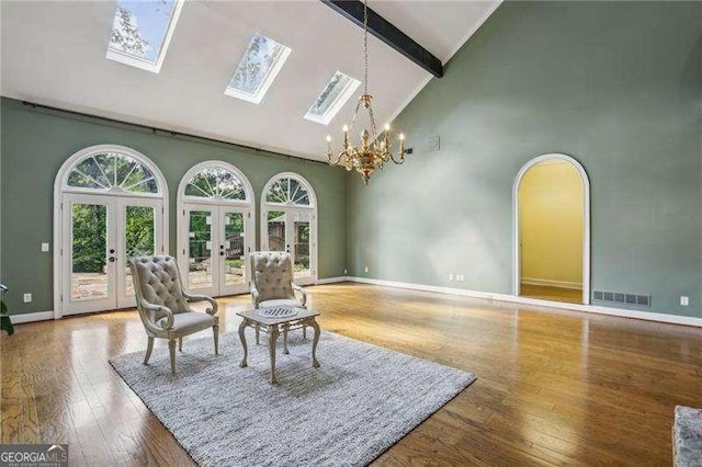 511 Pine Valley Rd SE, Marietta, GA 30067 - living area featuring high vaulted ceiling, french doors, a chandelier, beam ceiling, and hardwood / wood-style floors
