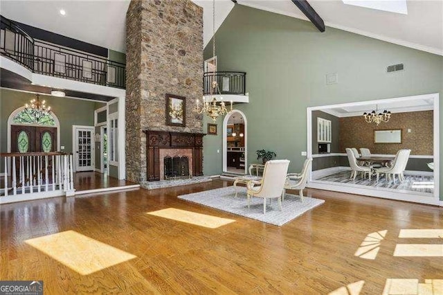 511 Pine Valley Rd SE, Marietta, GA 30067 - living room featuring a chandelier, high vaulted ceiling, wood finished floors, a fireplace, and beam ceiling