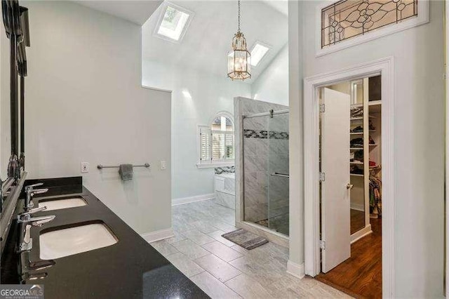 511 Pine Valley Rd SE, Marietta, GA 30067 - bathroom with a shower stall, a chandelier, double vanity, a walk in closet, and a bath