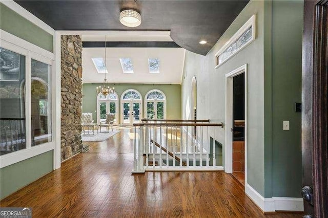 511 Pine Valley Rd SE, Marietta, GA 30067 - hall with wood finished floors, a chandelier, and an upstairs landing