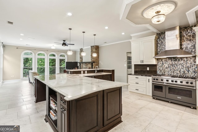 511 Pine Valley Rd SE, Marietta, GA 30067 - kitchen featuring double oven range, wall chimney exhaust hood, decorative backsplash, a ceiling fan, and ornamental molding
