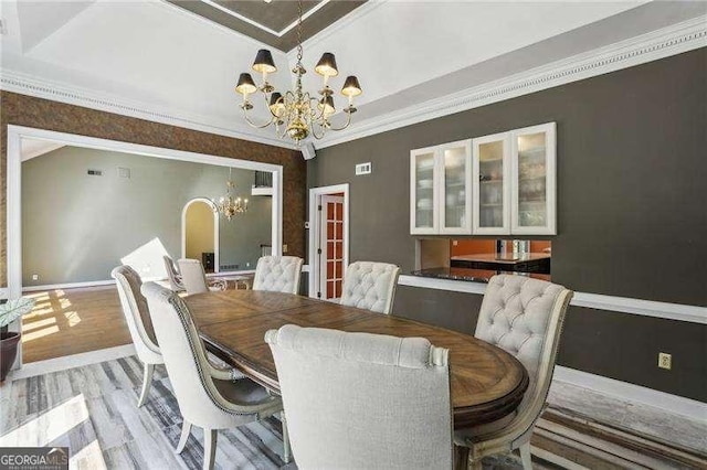511 Pine Valley Rd SE, Marietta, GA 30067 - dining space with a chandelier, light wood-style flooring, and ornamental molding