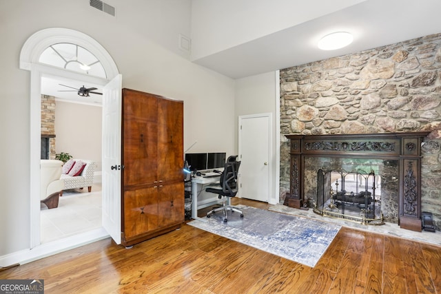 511 Pine Valley Rd SE, Marietta, GA 30067 - office space featuring a multi sided fireplace, wood finished floors, a ceiling fan, and a high ceiling