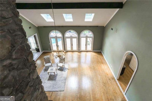 511 Pine Valley Rd SE, Marietta, GA 30067 - living area featuring a skylight, healthy amount of natural light, crown molding, wood finished floors, and lofted ceiling