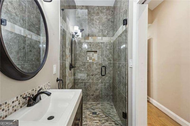 511 Pine Valley Rd SE, Marietta, GA 30067 - bathroom featuring a stall shower, wood finished floors, and vanity