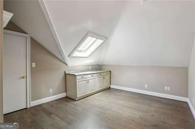 511 Pine Valley Rd SE, Marietta, GA 30067 - additional living space featuring a skylight, vaulted ceiling, and light wood finished floors
