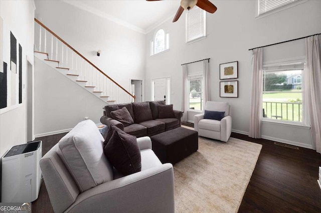 2820 Channing Way, Cumming, GA 30040 - living room with dark wood-type flooring, a towering ceiling, ceiling fan, baseboards, and stairs