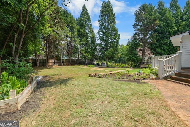 2820 Channing Way, Cumming, GA 30040 - view of yard featuring a vegetable garden and view of scattered trees