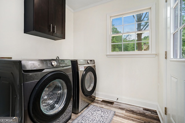 2674 Skylane Dr, Marietta, GA 30062 - laundry room featuring washer and dryer, wood finished floors, crown molding, and cabinet space
