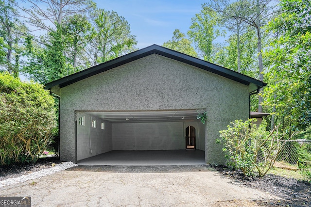 2674 Skylane Dr, Marietta, GA 30062 - view of side of home featuring stucco siding, a garage, and asphalt driveway