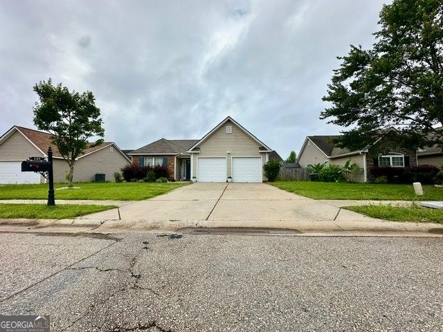 298 Timberwind Dr, Byron, GA 31008 - view of front of property with a garage, concrete driveway, and a front yard
