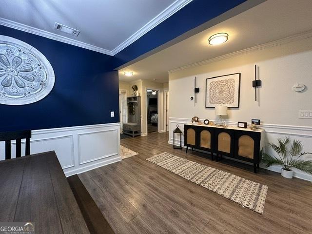 298 Timberwind Dr, Byron, GA 31008 - interior space featuring a decorative wall, wood finished floors, a wainscoted wall, and ornamental molding