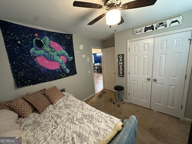 298 Timberwind Dr, Byron, GA 31008 - carpeted bedroom featuring baseboards, ceiling fan, and a closet