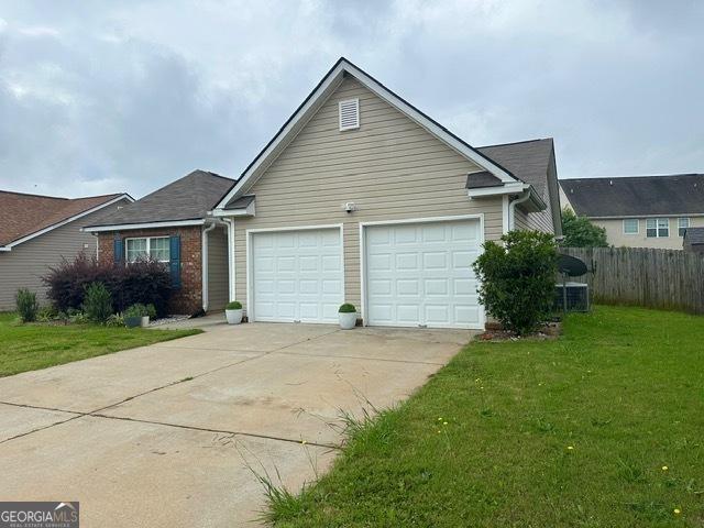 298 Timberwind Dr, Byron, GA 31008 - view of front of home with an attached garage and concrete driveway
