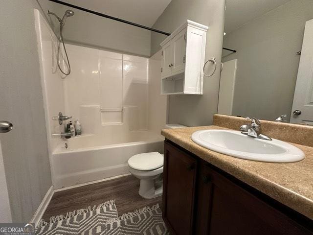 298 Timberwind Dr, Byron, GA 31008 - bathroom featuring wood finished floors, vanity, toilet, shower / washtub combination, and baseboards