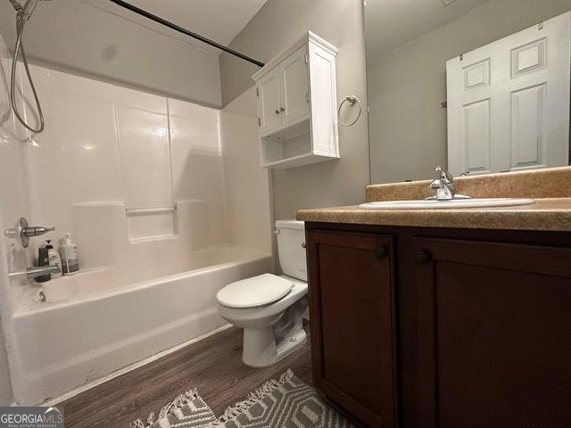 298 Timberwind Dr, Byron, GA 31008 - bathroom featuring toilet, wood finished floors, vanity, and shower / bathtub combination