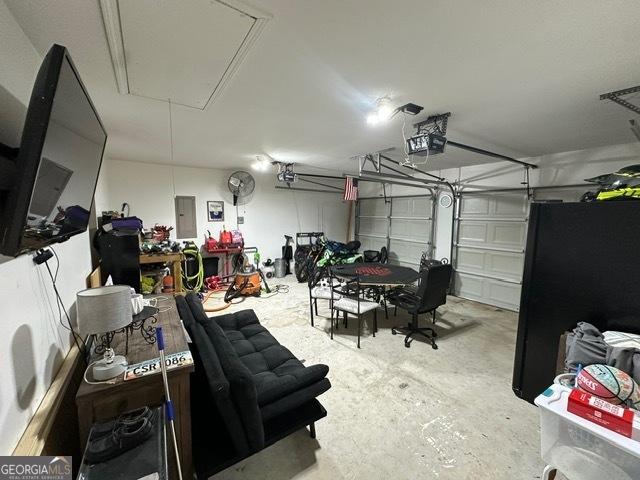 298 Timberwind Dr, Byron, GA 31008 - garage with a garage door opener and electric panel