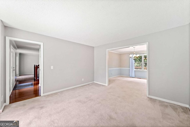 308 Golden Ct, Canton, GA 30114 - spare room featuring carpet floors, a chandelier, baseboards, and a textured ceiling