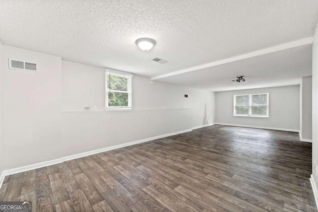 308 Golden Ct, Canton, GA 30114 - spare room featuring dark wood finished floors, healthy amount of natural light, a textured ceiling, and baseboards